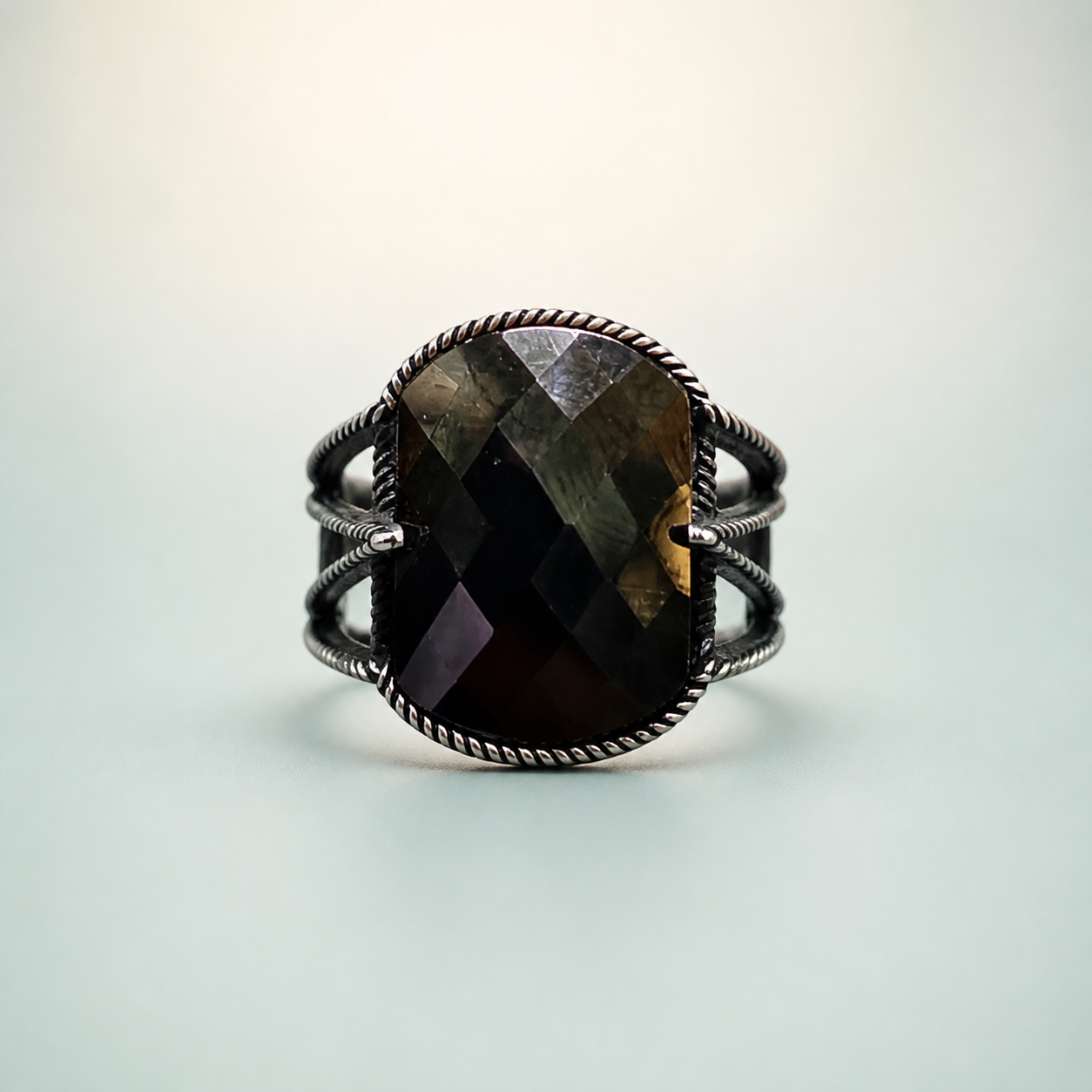 Dark Faceted Rope-Bezel Split-Shank Ring - 925 Sterling Silver on seaglass background