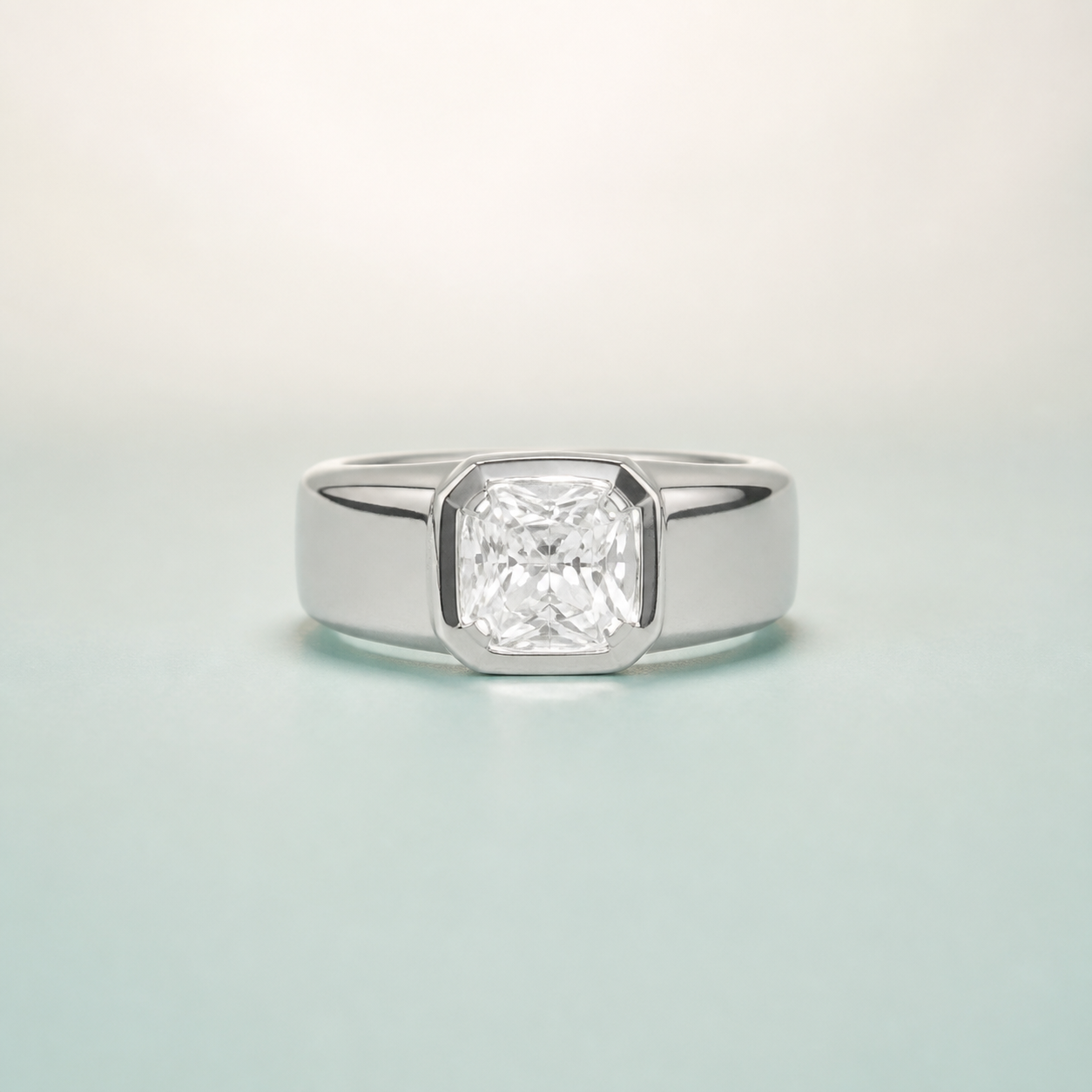 Cushion-Cut Flush-Bezel Solitaire Men's Ring (bright rhodium silver · clear-white CZ) - 925 Sterling Silver on seaglass background
