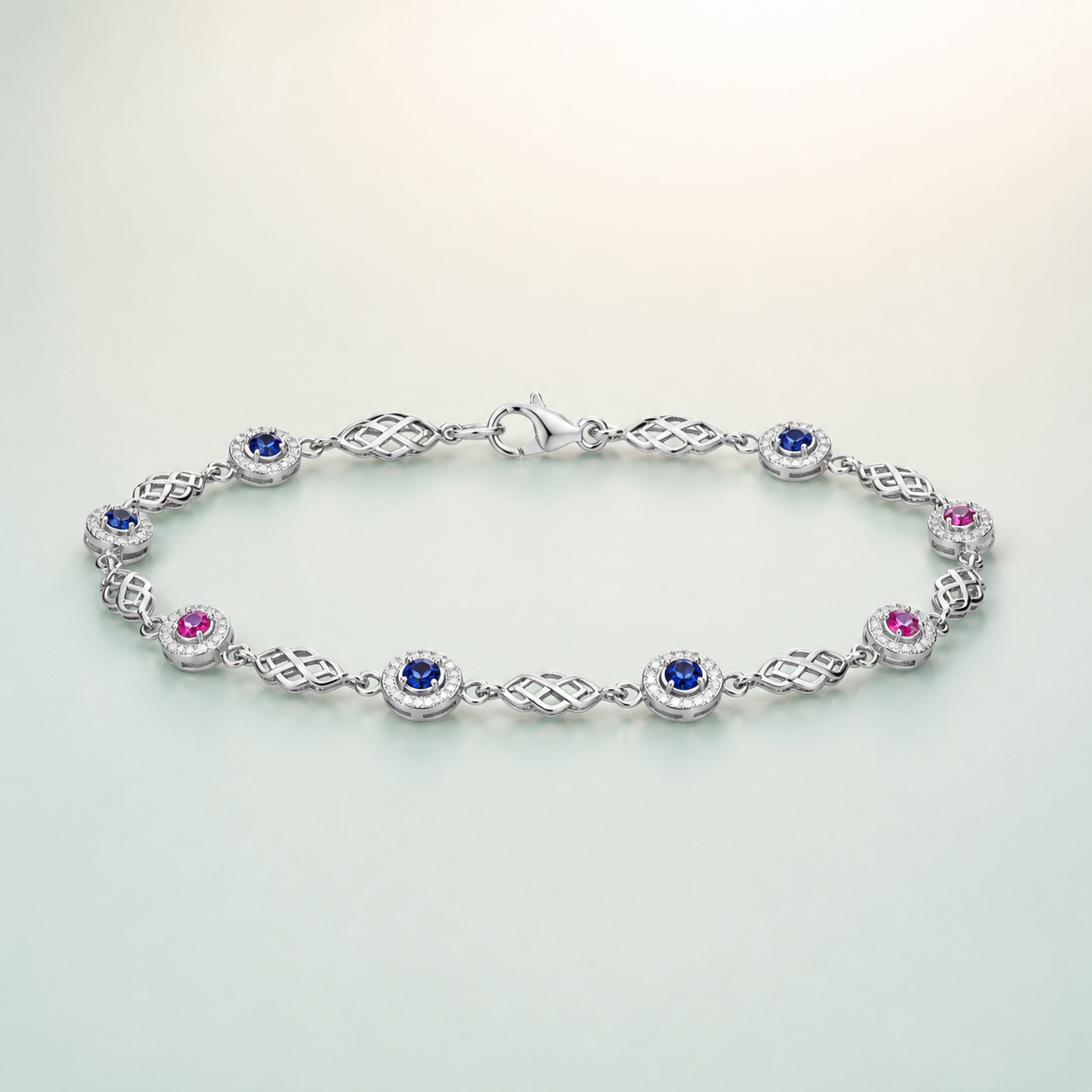 Celtic Knot & Sapphire Station Bracelet (bright polished silver · deep blue sapphire + pink ruby CZ) - front - 925 Sterling Silver
