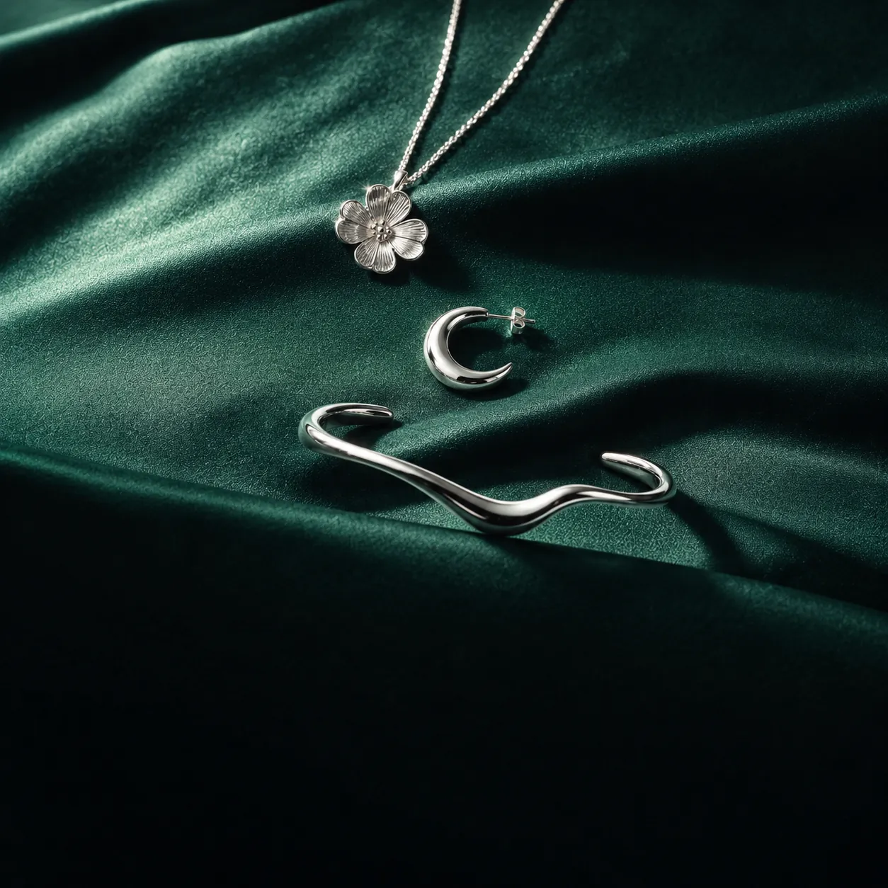A bold sterling silver collar necklace on deep emerald velvet