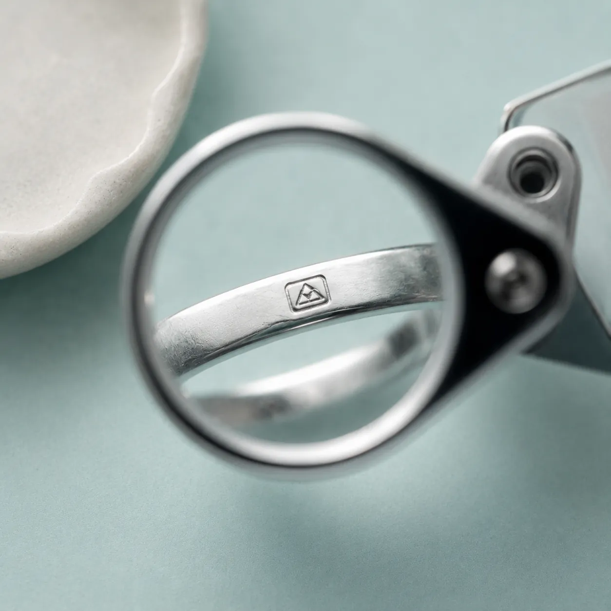 A hallmark inspected through a jeweller's loupe