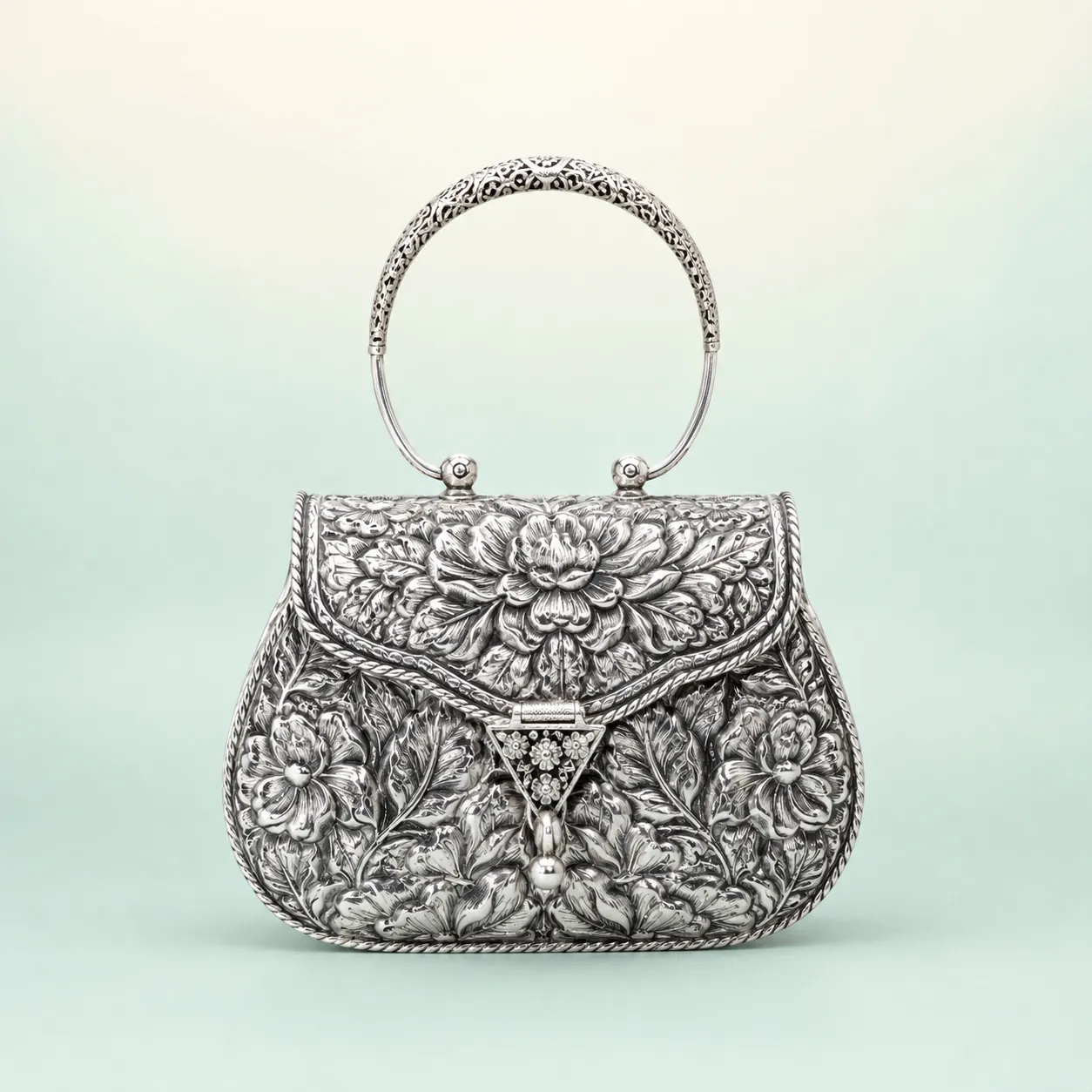 Bold Floral Repoussé Handle Purse — oxidised trapezoid handbag on seaglass background
