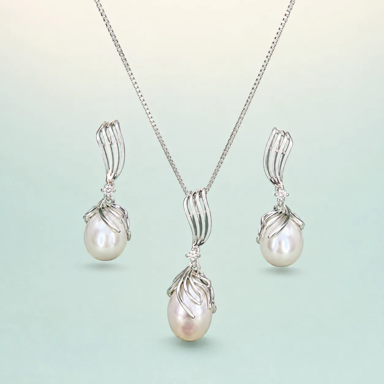 Pearl Wing-Cap Drop Set — bright silver, cream baroque pearls on seaglass background